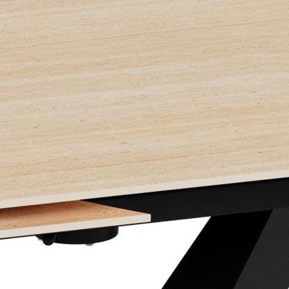 Close-up detail of a light ceramic tabletop with a black metal support leg visible underneath on a white background.