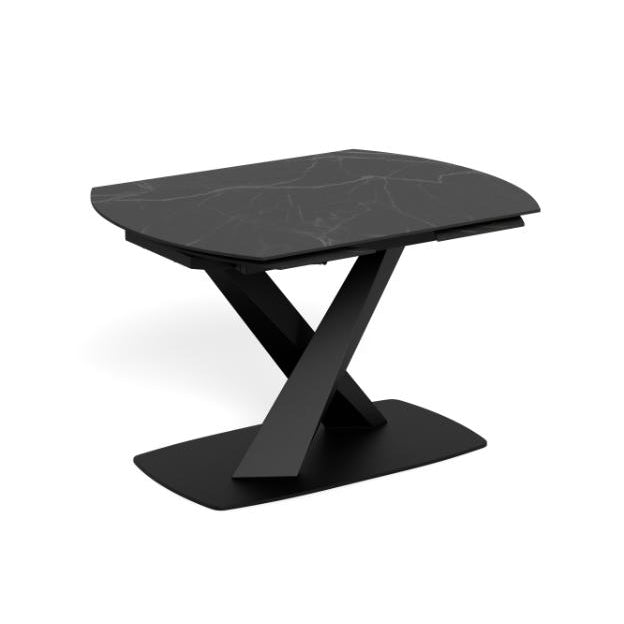 A modern black extendable dining table  with a curved rectangular top featuring subtle white marble veining, supported by a matte black X-shaped pedestal base on a white background.