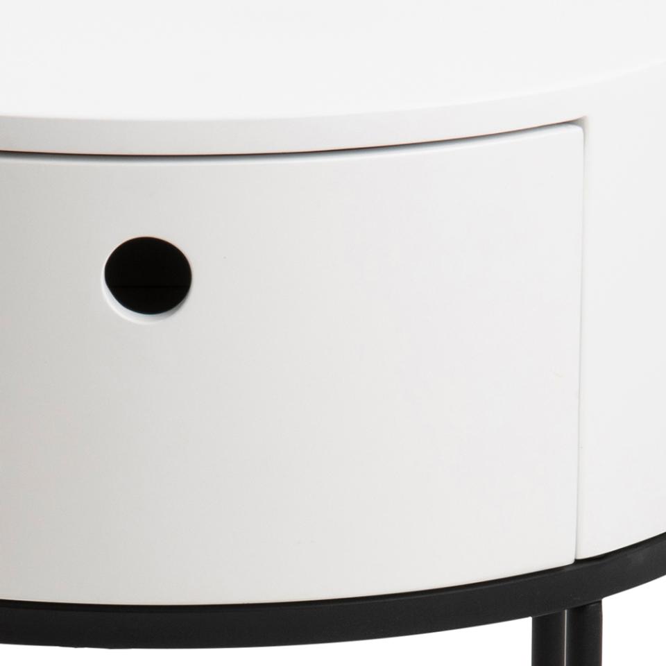 White cylindrical object with a black circular feature on a white background