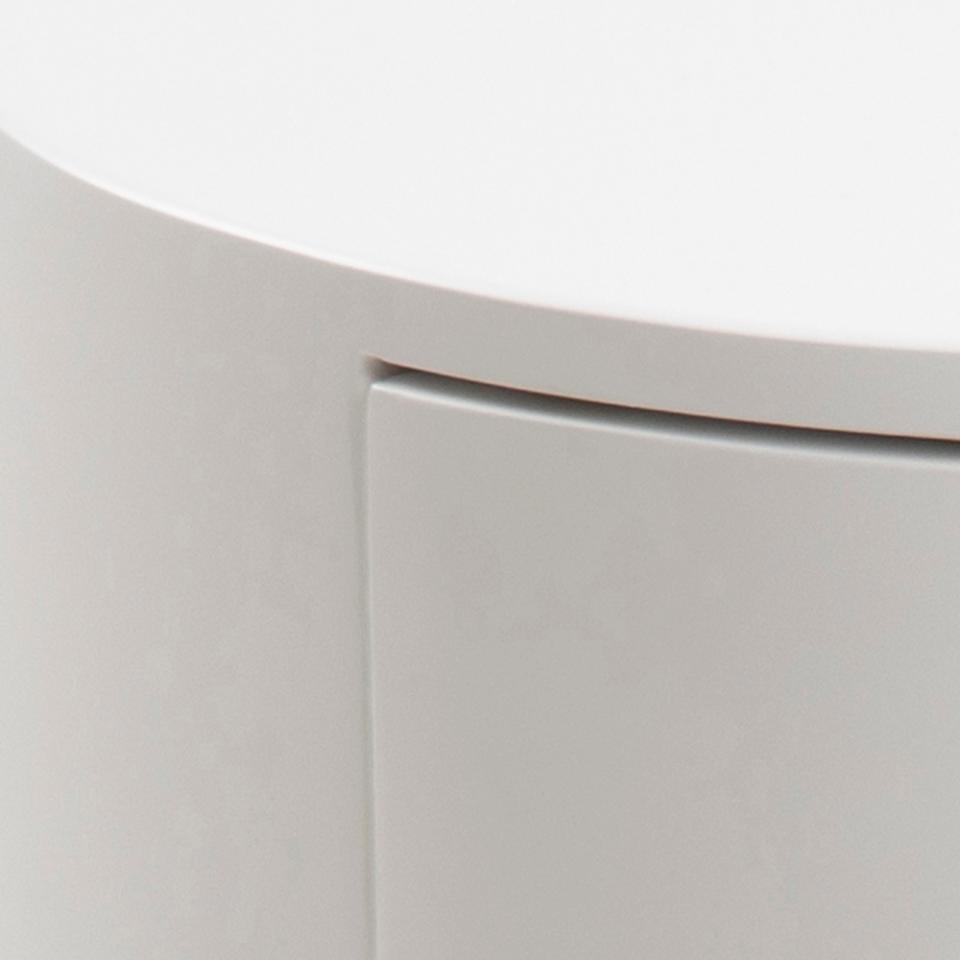 Close-up of a light gray cabinet or side table showing the top edge, front panel, and a subtle seam detail.