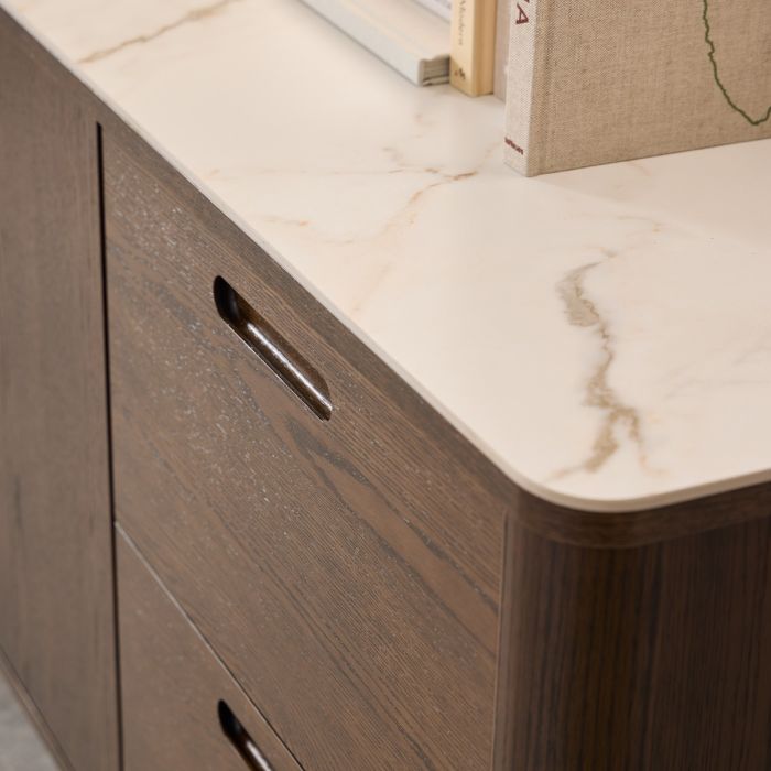 Wooden cabinet with marble ceramic top and books on top