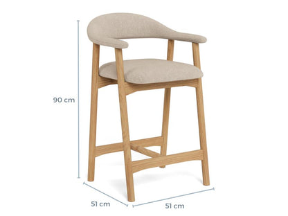 Beige Addi bar stool with wooden legs and measurements on a white background