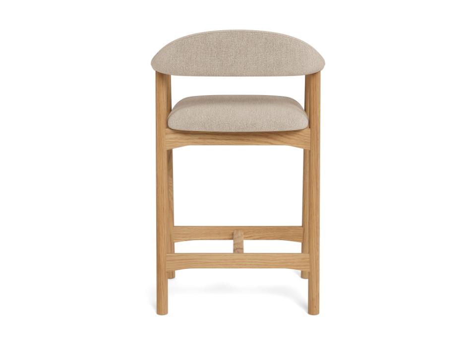 Wooden bar stool with beige cushioned seat and backrest on a white background