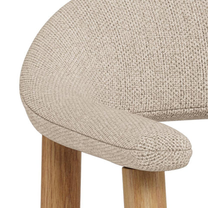 Close-up of a beige textured stool with wooden legs on a white background
