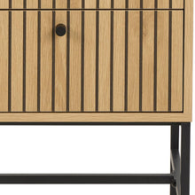 Load image into Gallery viewer, Close-up of a wooden cabinet with vertical slat detailing, a round black knob, and a black metal frame leg against a white background.
