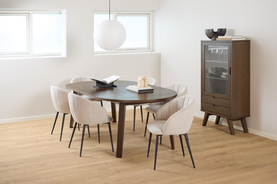 Dining room with wooden table and chairs, and a cabinet against a white wall.