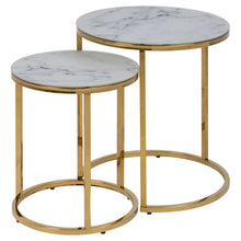 Load image into Gallery viewer, Two nested round nesting side tables with white marble-patterned tops and polished gold metal frames, shown on a plain white background.
