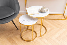 Load image into Gallery viewer, Modern side table with marble top and gold legs in a minimalistic room.
