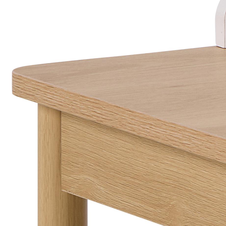 Close-up of a wooden desk corner with a white chair partially visible.