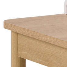Load image into Gallery viewer, Close-up of a wooden desk corner with a white chair partially visible.

