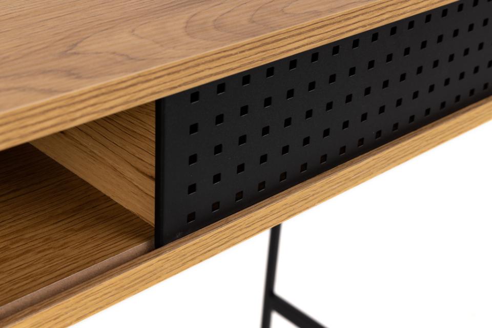 Wooden desk with black perforated panel on a white background