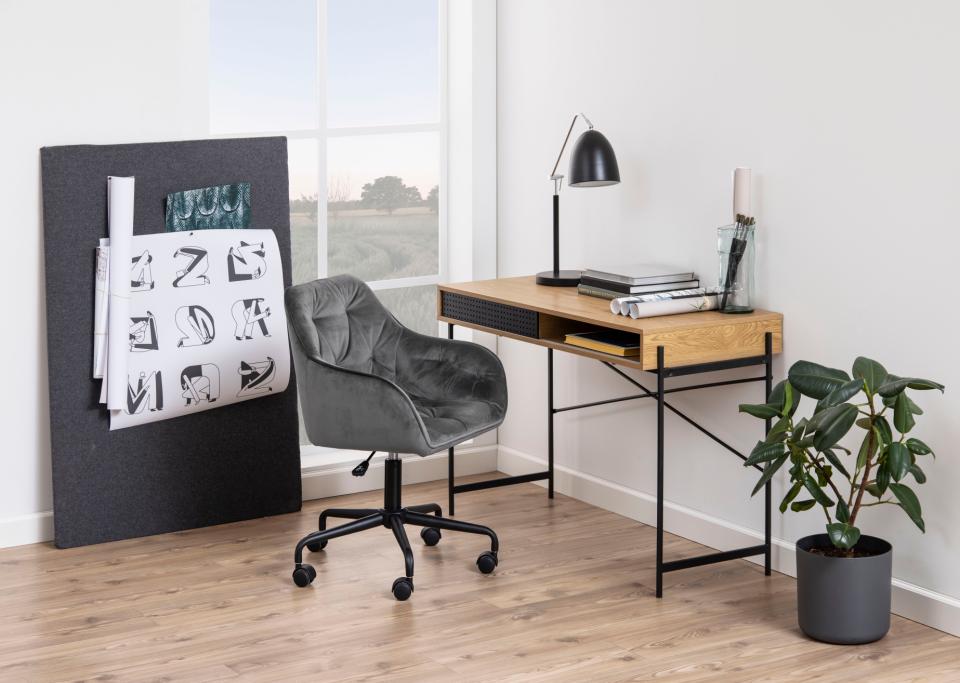 Modern office setup with a desk, chair, and decorative elements.