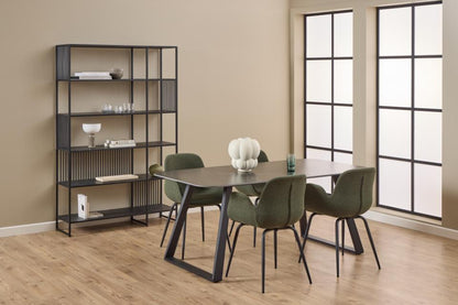 Dining room with a table and chairs near a bookshelf against a beige wall.
