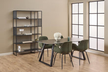 Load image into Gallery viewer, Dining room with a table and chairs near a bookshelf against a beige wall.
