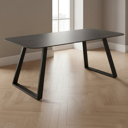Black dining table with a minimalist design on a white background