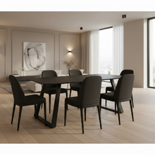 Load image into Gallery viewer, A modern dining set featuring a rectangular black table and six matching black upholstered chairs, styled in a contemporary, minimalist dining room with light wood floors and neutral walls.
