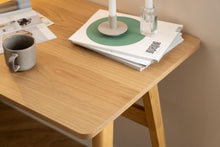 Load image into Gallery viewer, Wooden desk with a mug, books, and a candle on a neutral background
