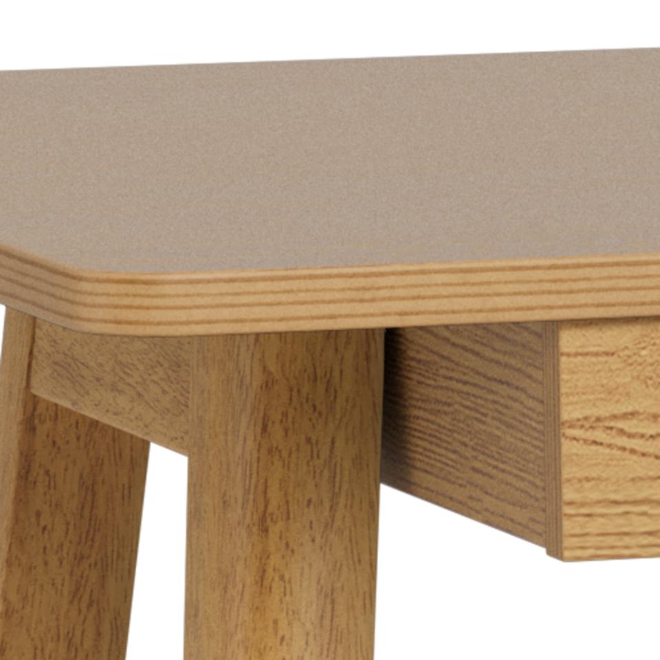Wooden table with a beige cushioned top on a white background