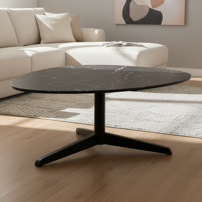 Modern black coffee table in a living room setting with a beige sofa and abstract art on the wall.