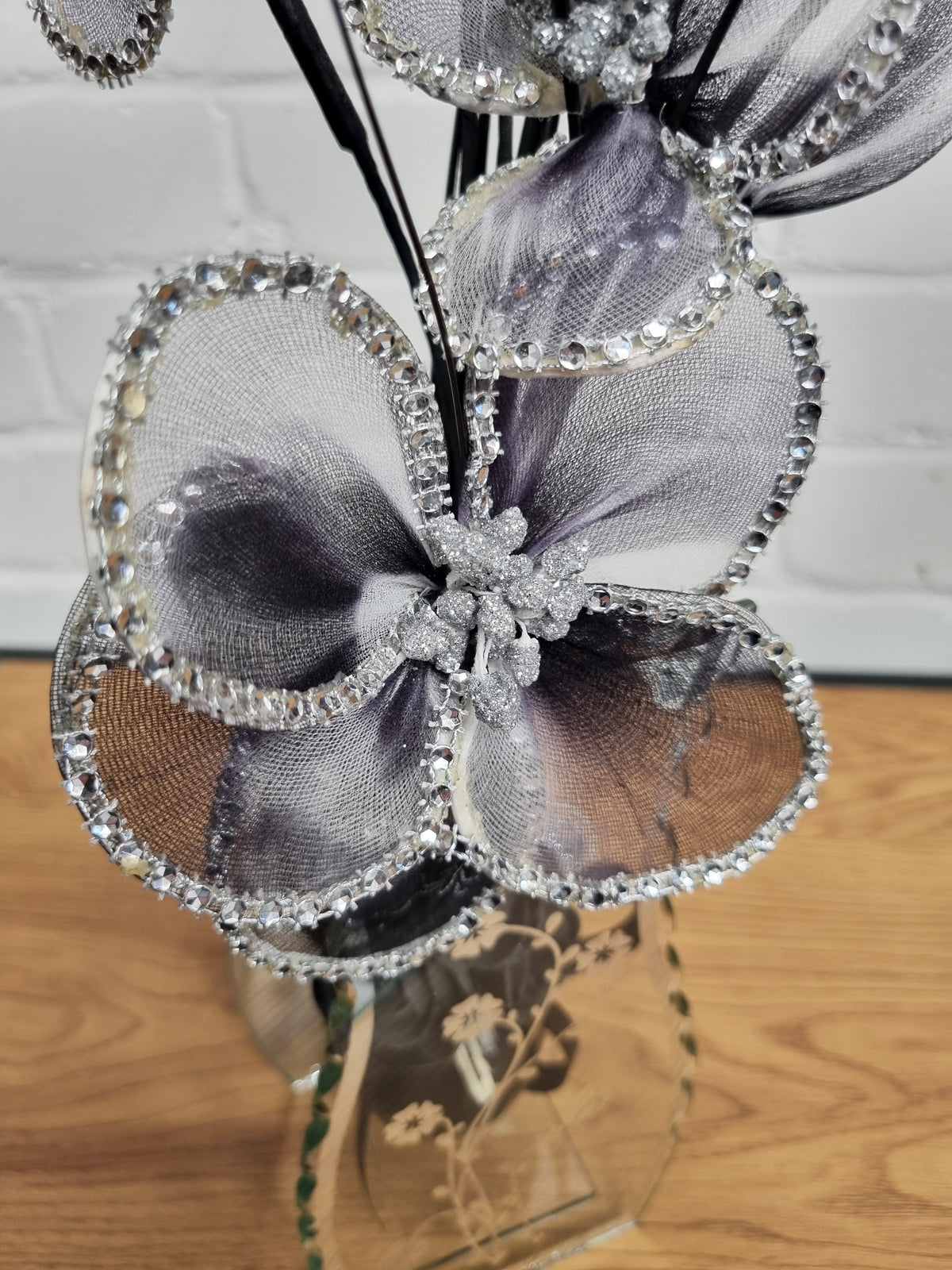 close up of a black nylon flower with stunning diamante detailing around the petals