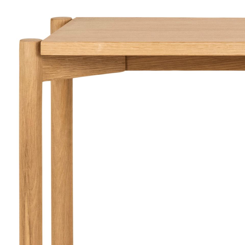 Close-up of a wooden table corner on a white background