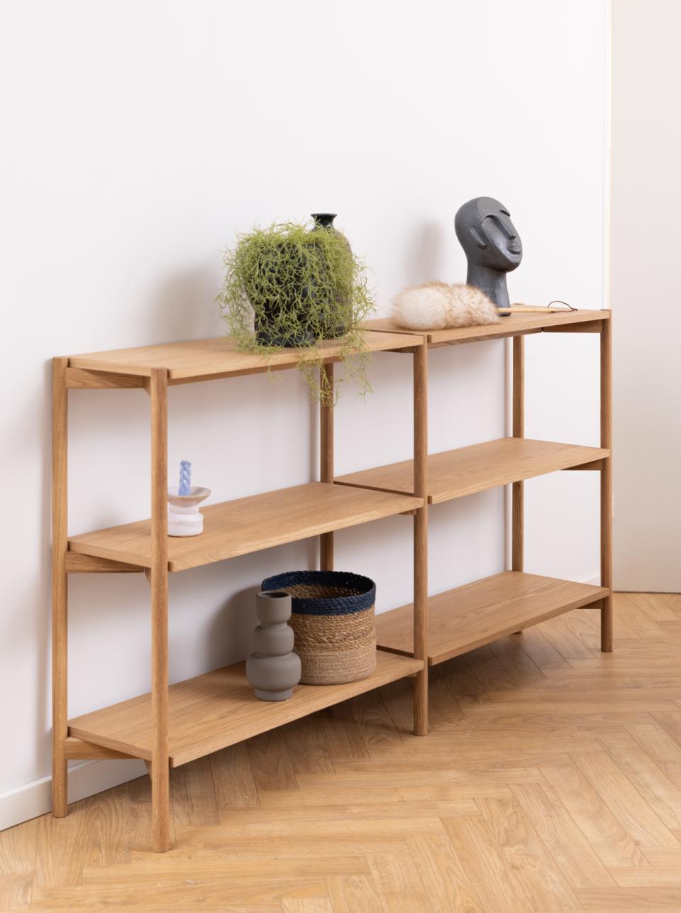 Wooden shelf with decorative items against a white wall