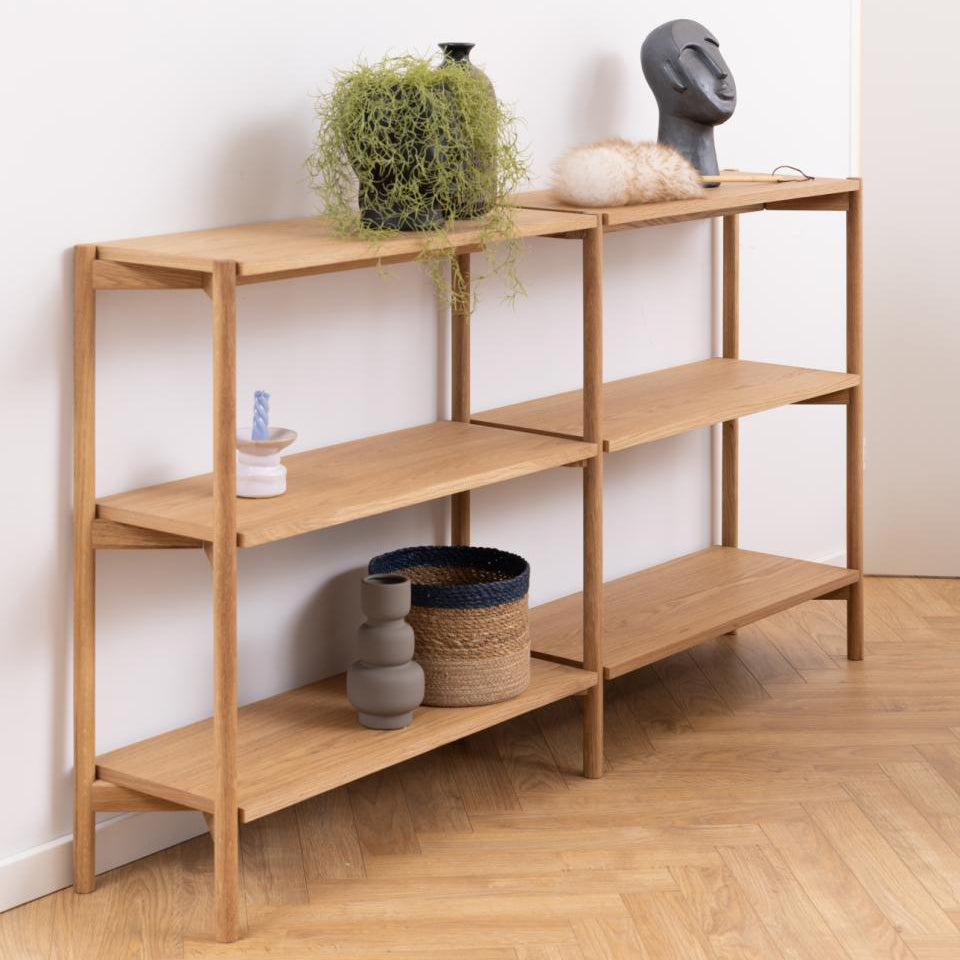 Wooden shelf with decorative items against a white wall