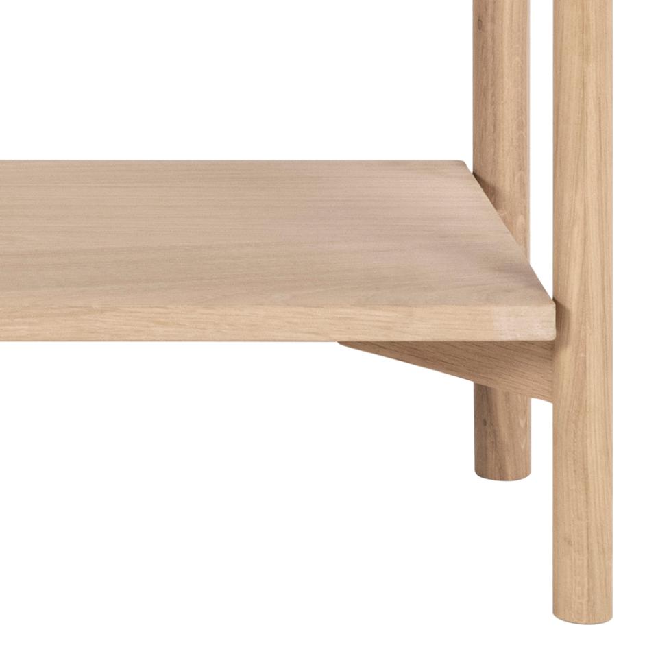 Close-up of a light natural oak wood shelf and its matching cylindrical legs on a solid white background.