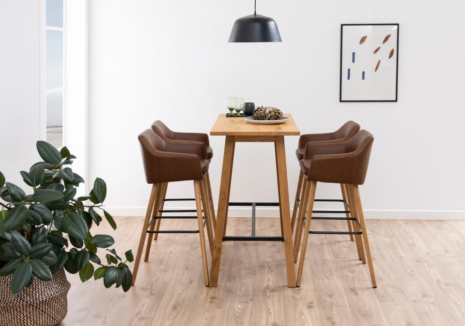 A Chara bar table with 4 bar stools in a modern home