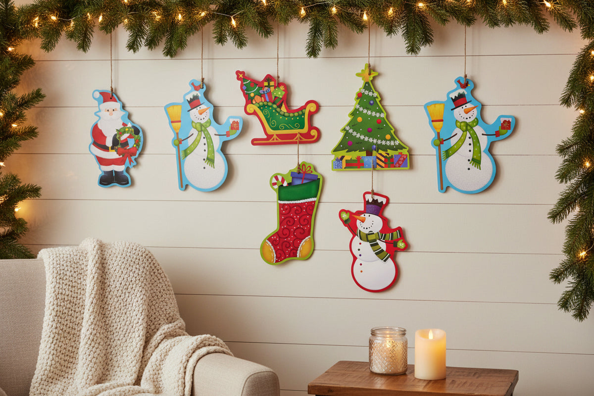 Six Christmas-themed decorative cutouts on a white background: Santa Claus, a sleigh full of gifts, a Christmas tree, a snowman with a broom, a red stocking, and another snowman.
