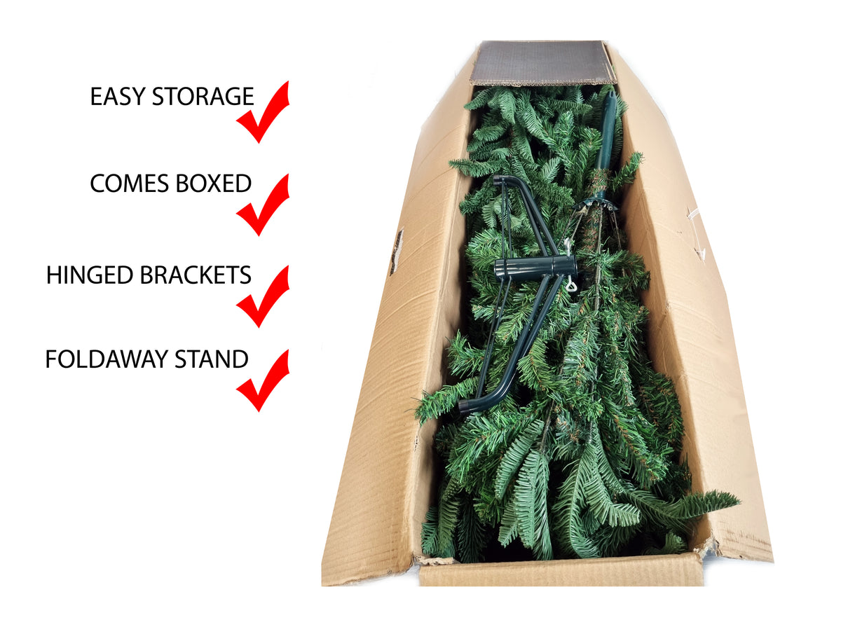 An artificial Christmas tree in a brown cardboard box with feature callouts on the left: 'EASY STORAGE', 'COMES BOXED', 'HINGED BRACKETS', and 'FOLDAWAY STAND', each checked with a red checkmark, on a white background.