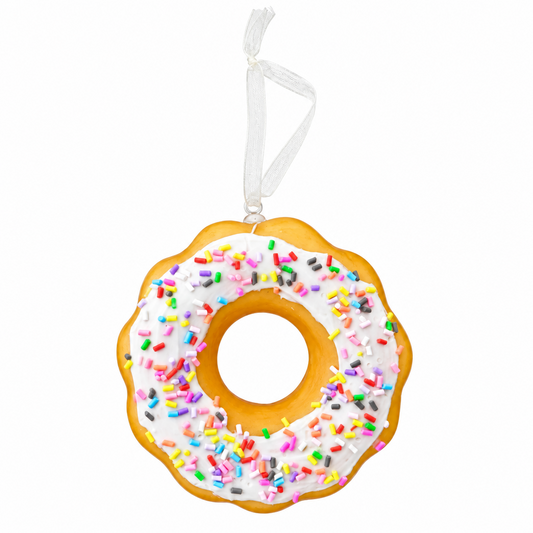 A donut-shaped hanging ornament with white frosting and multicolored sprinkles, suspended by a white ribbon on a plain white background.