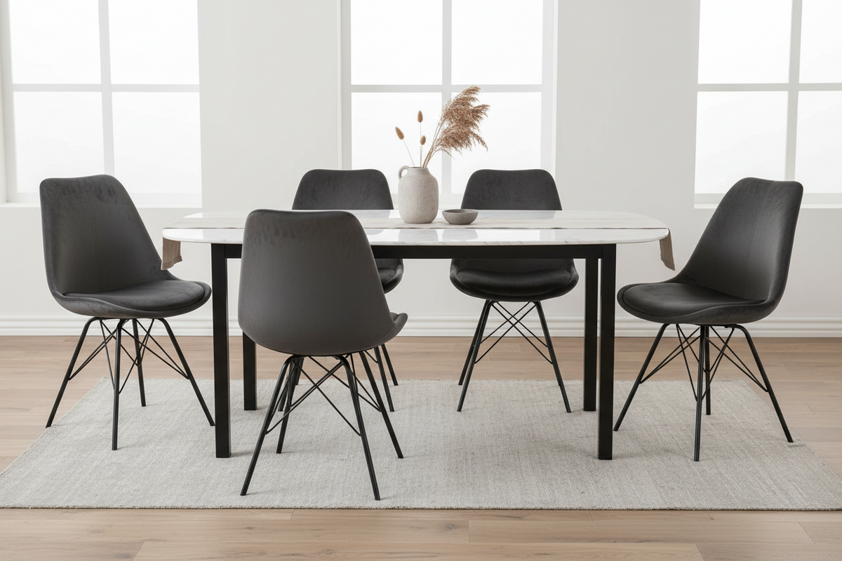 A modern dining set featuring a rectangular white marble-top table with black legs and six matching black molded plastic chairs with black wire legs, arranged on a light gray rug in a bright room with large windows.