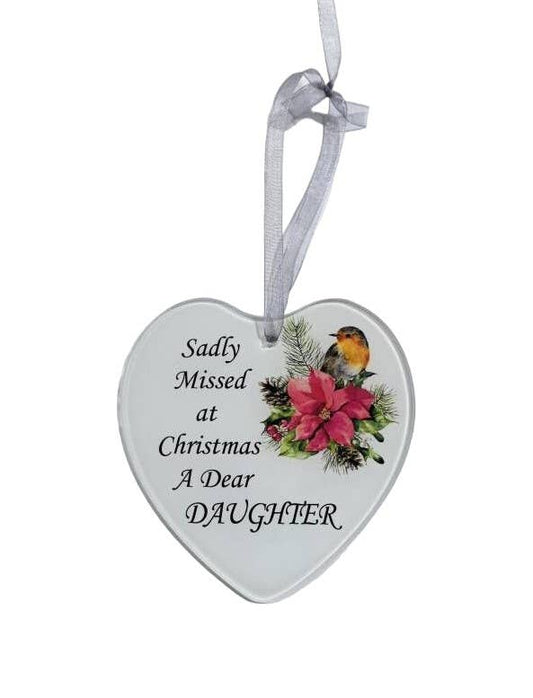 A heart-shaped glass hanging decoration with a poinsettia flower and a robin, with the text 'Sadly missed at Christmas a dear Daughter'.