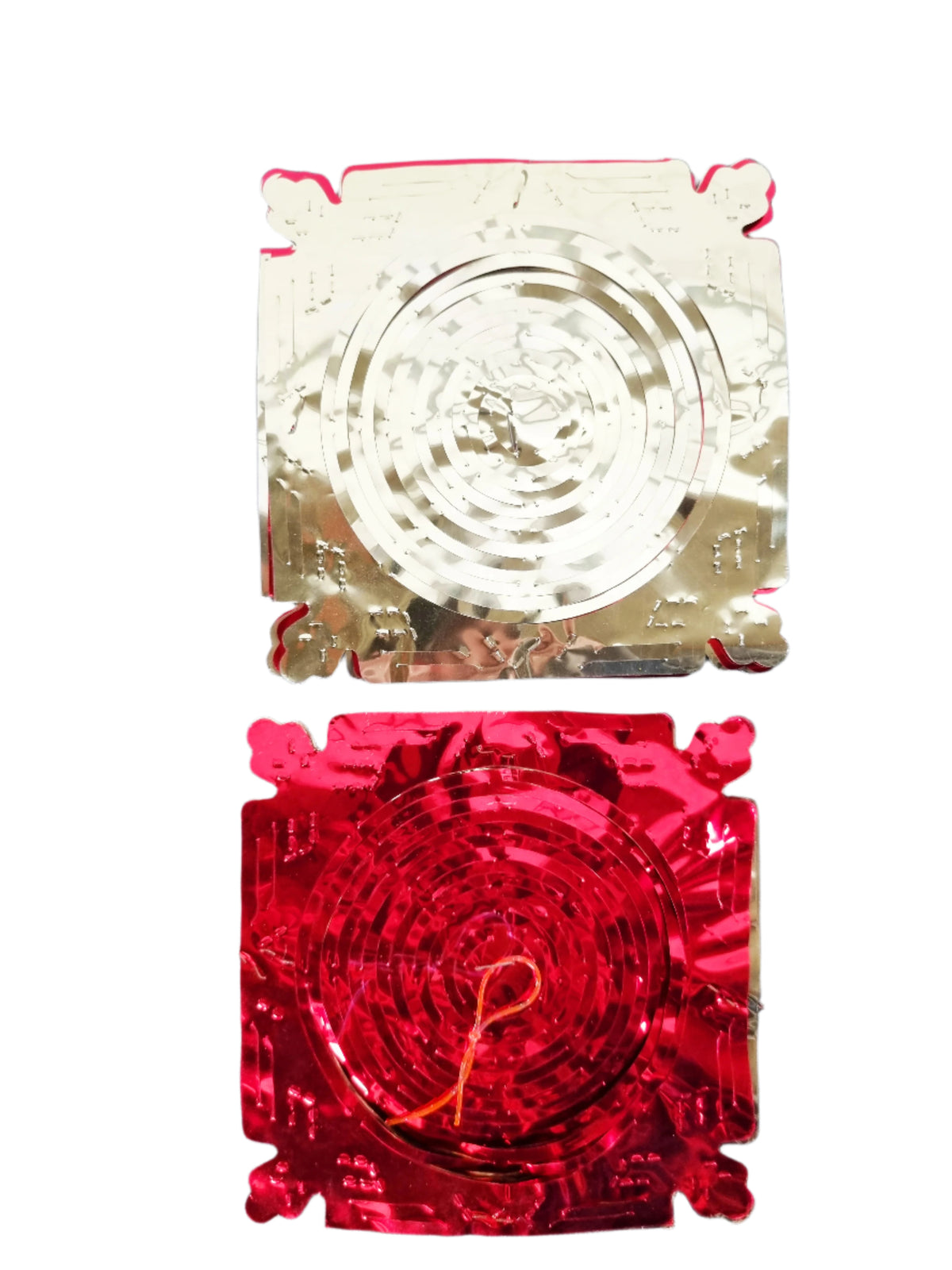 Two square metallic decorative plates or trays shown on a plain white background, one in silver-toned metal with engraved circular patterns and the other in red-toned metal with concentric circular patterns.