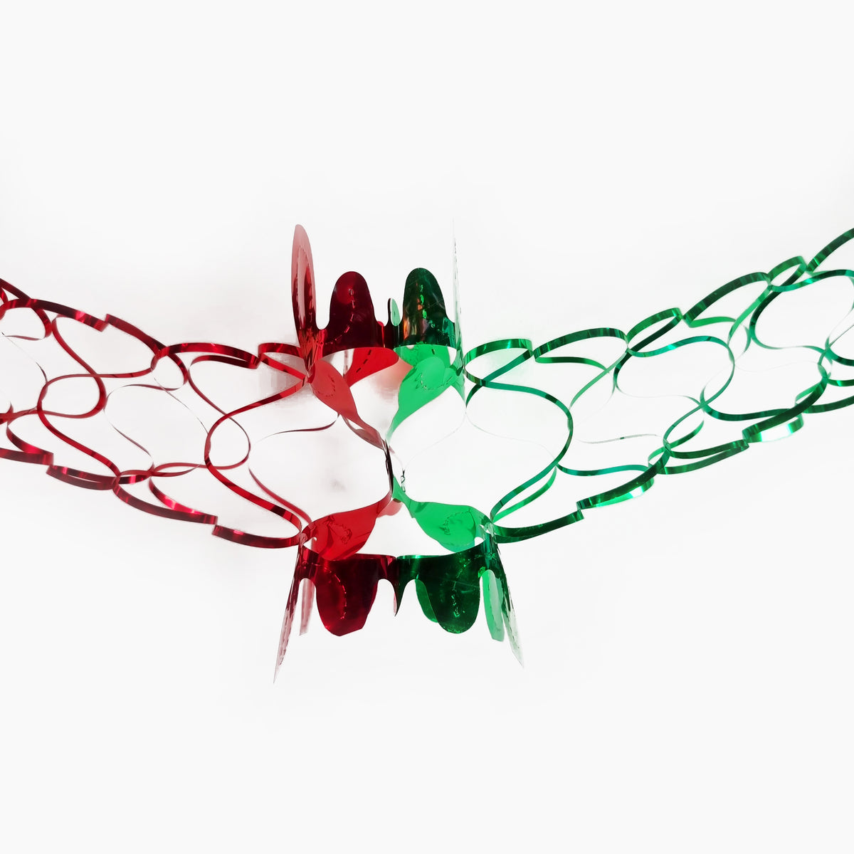 Red and green metallic tinsel ribbon garlands arranged in a heart shape on a plain white background.