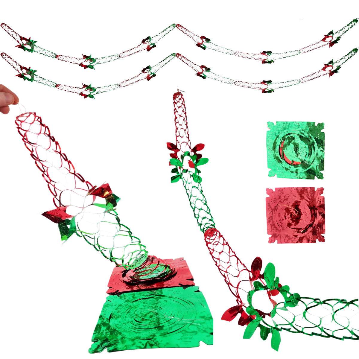 Christmas-themed metal wind spinner decorations featuring red and green foil swirls, wire mesh structures, and small holly leaf accents, shown on a plain white background with a hand partially visible at the left edge.