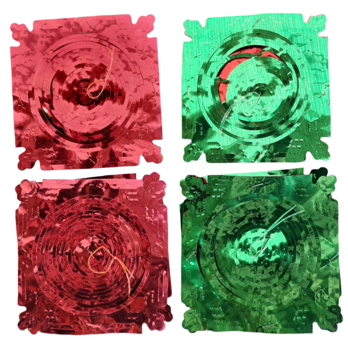Four square metallic Christmas foil decorations with scalloped edges, arranged in a 2x2 grid. Two patches are red and two are green, each featuring concentric circular patterns and small wire loops in the center.