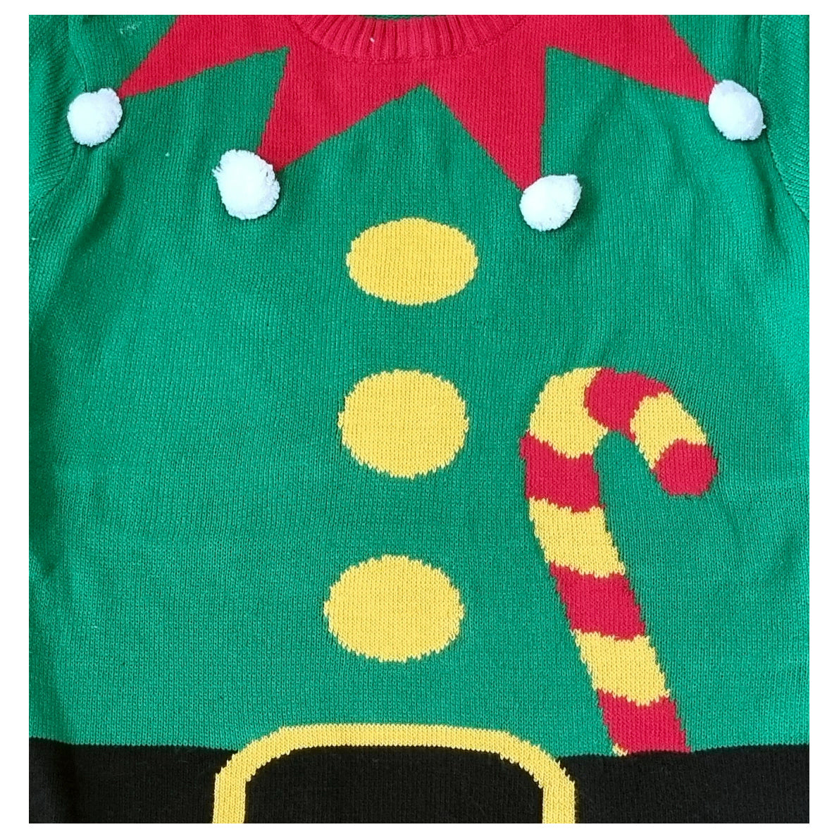 A close-up of a green Christmas elf sweater featuring a red hat with white pom-poms, yellow buttons, a red-and-yellow candy cane, and a black belt at the bottom.