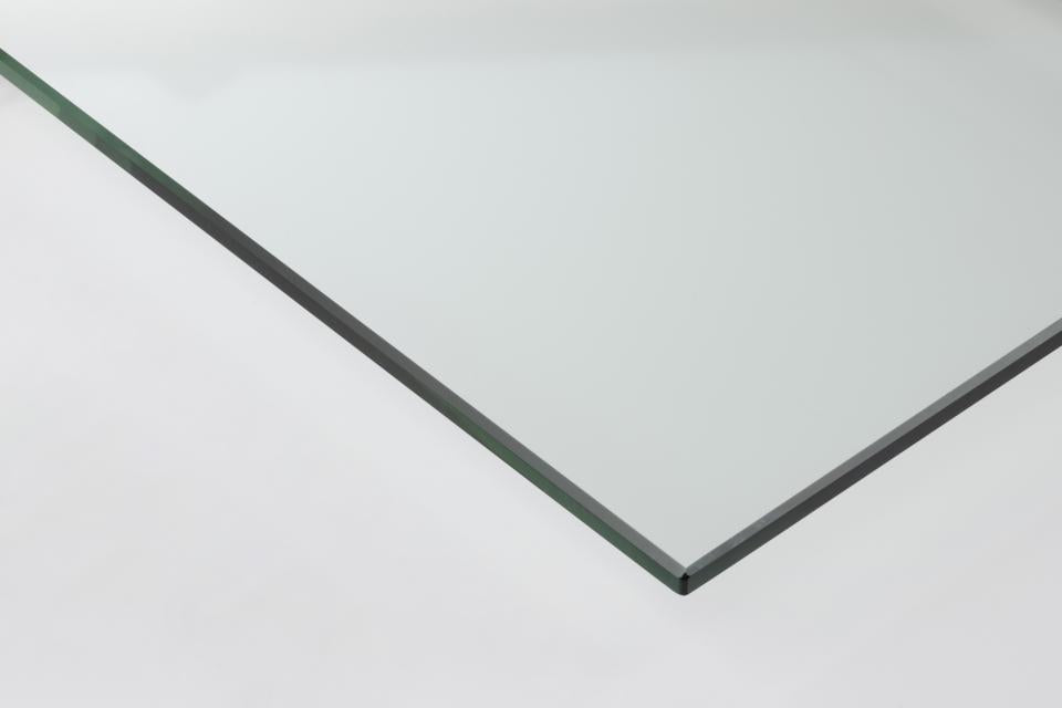 Sheet of glass with a green edge on a white background