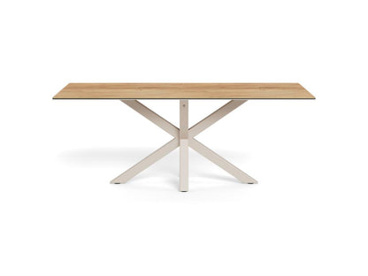A modern rectangular dining table with a light oak wood top and a white painted metal X-shaped base, shown on a solid white background.