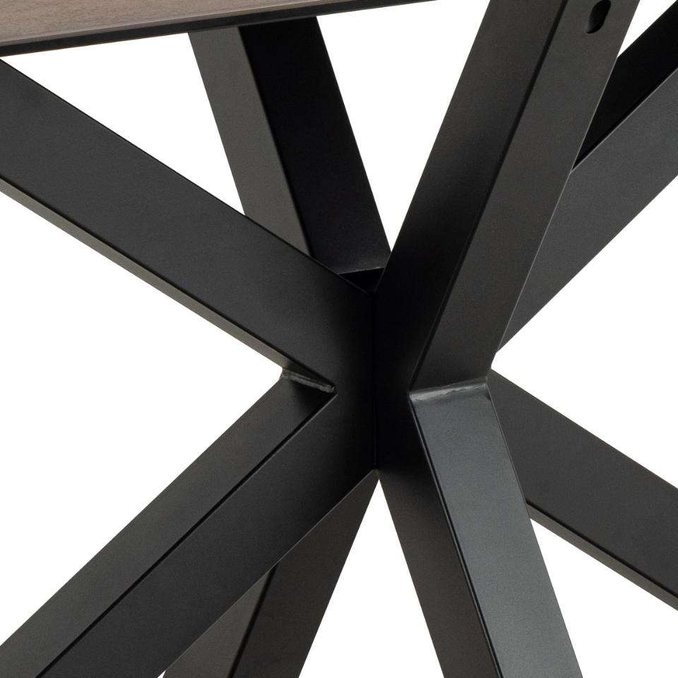 Close-up of a black metal chair leg design on a white background