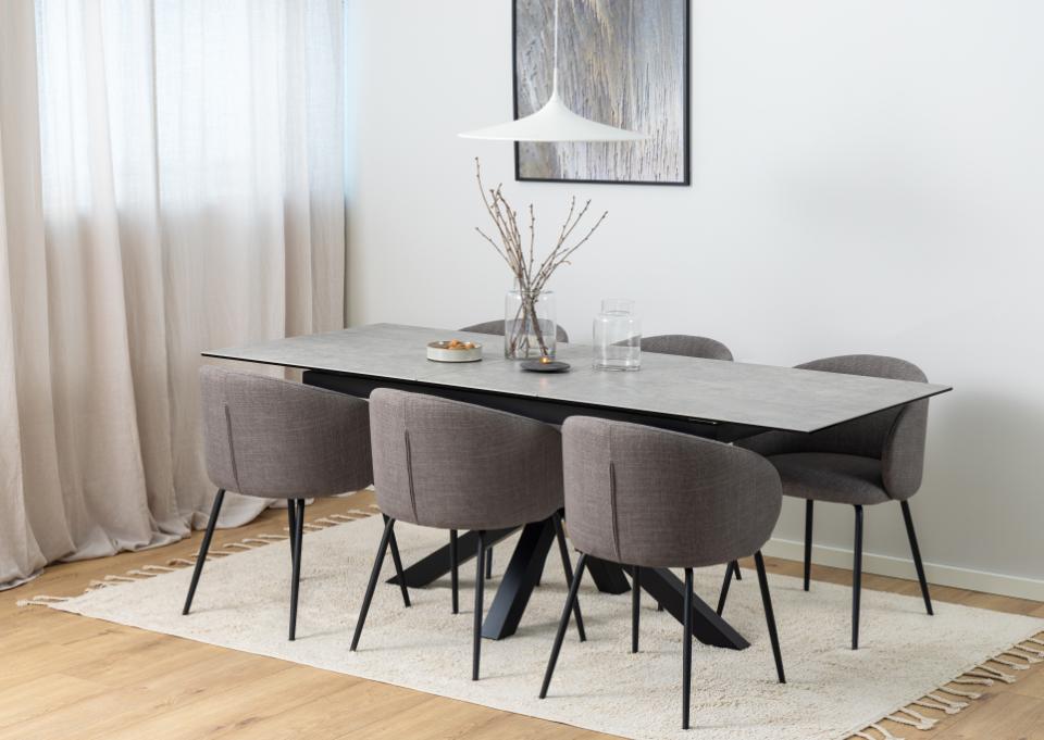 Dining room with a table and chairs in a modern interior setting.