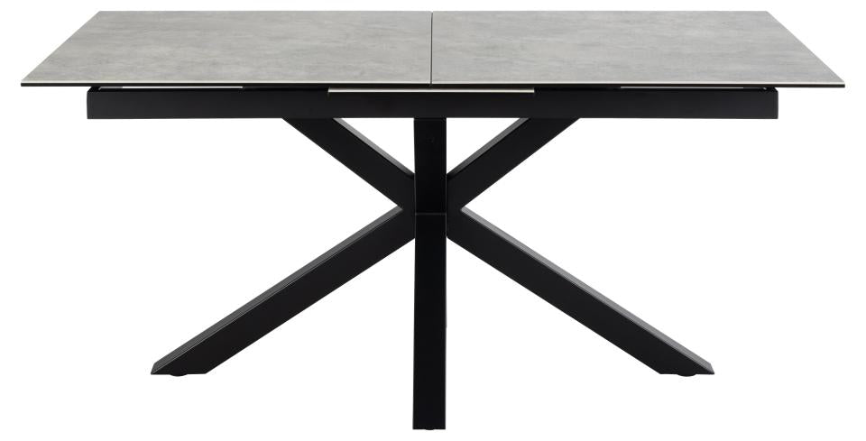 A modern rectangular dining table with a gray stone-look top and a black metal X-shaped pedestal base, shown on a plain white background.