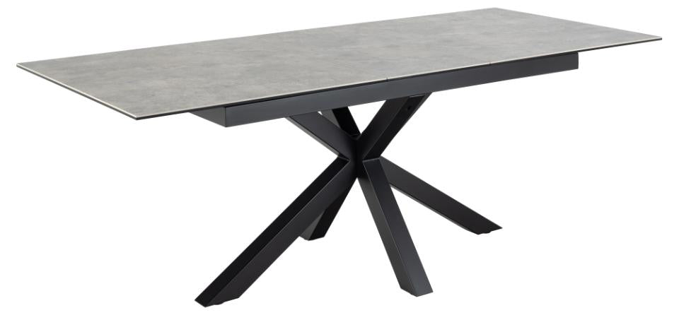 Dining table with a gray top and black metal base on a white background