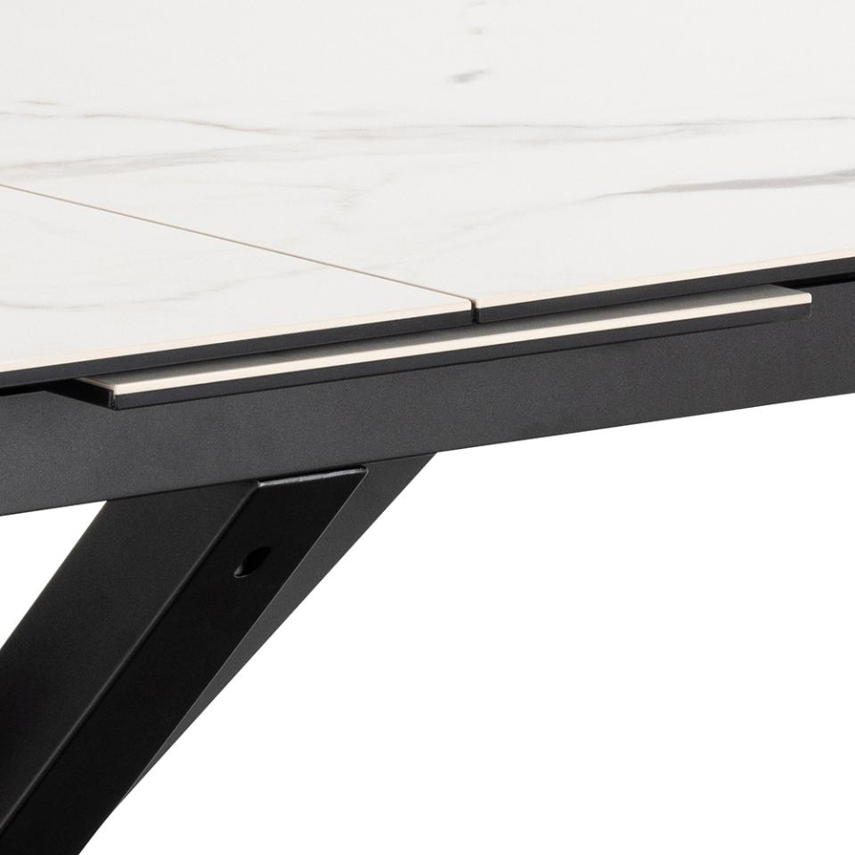 Close-up of a black metal table leg on a white background