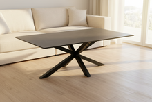Load image into Gallery viewer, A rectangular coffee table with a black ceramic top and a cross base made of matt black rough powder coated metal.
