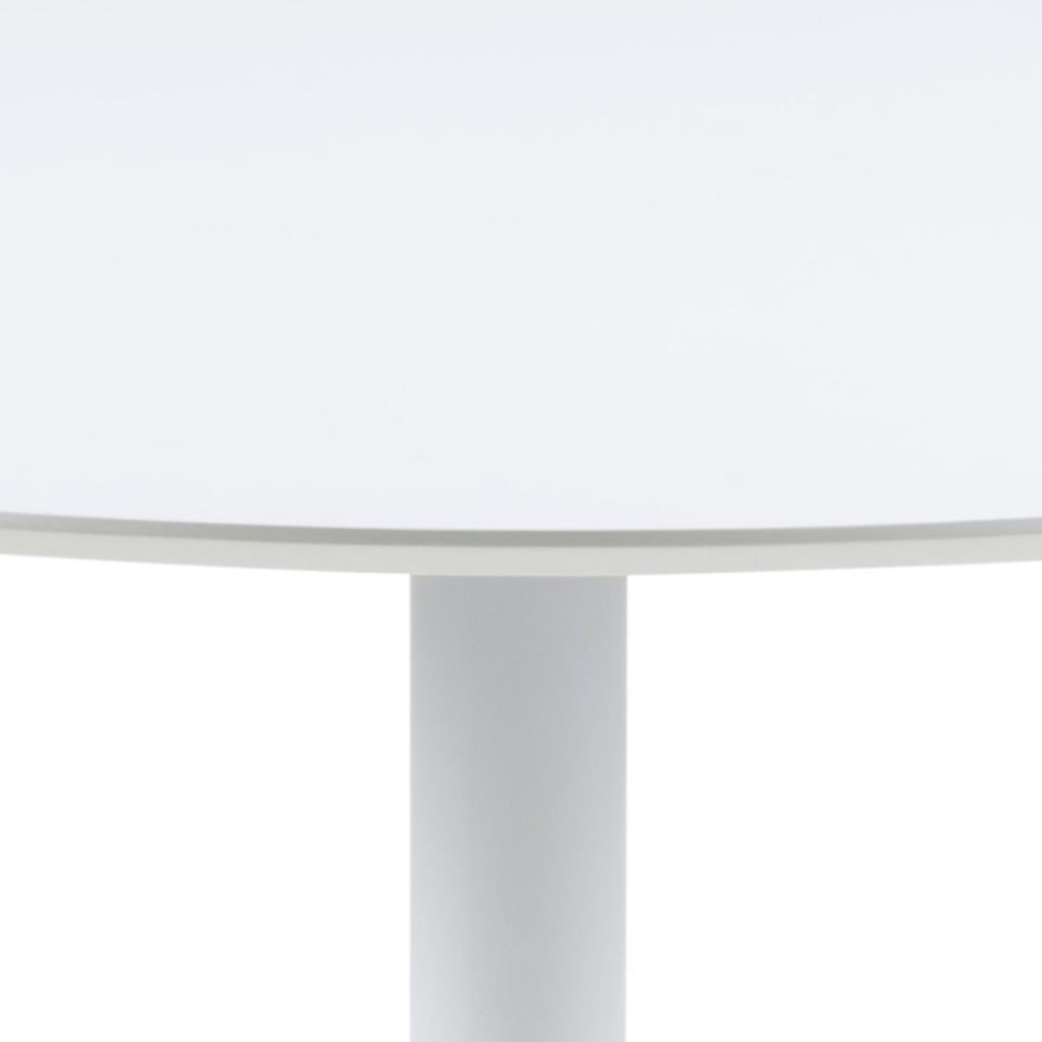Close-up of a white table with a cylindrical leg.