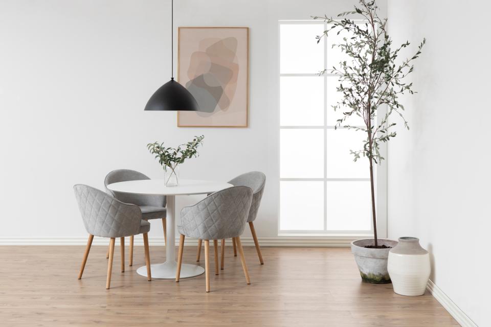 Modern dining room with round table and chairs.