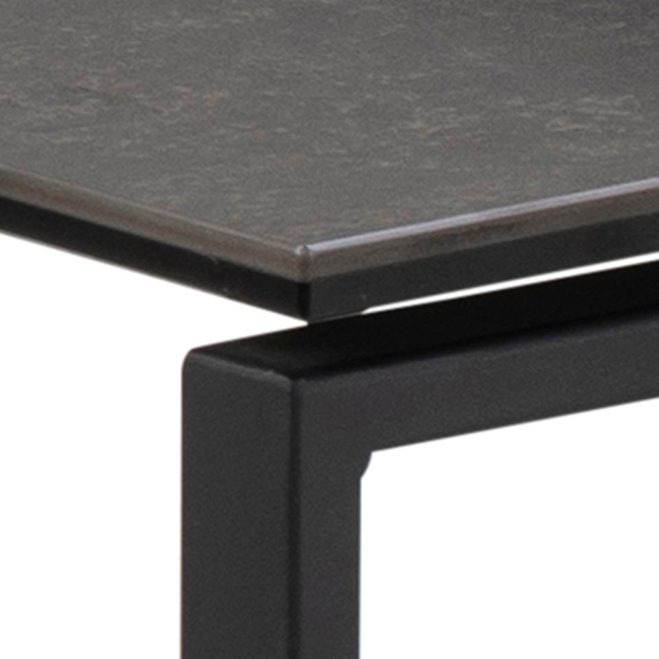 Close-up of a black metal table with a dark gray surface.